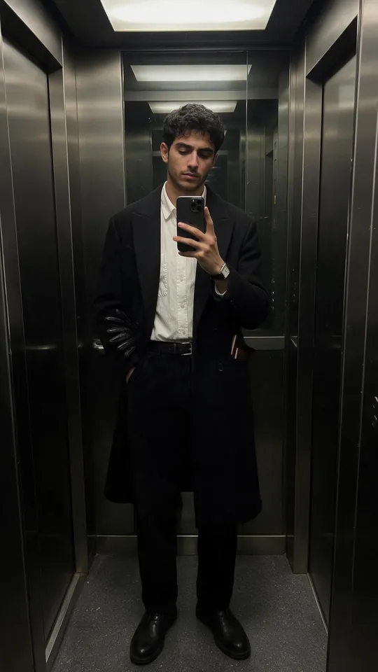 Dark Aesthetic men's outfit: long black coat, white shirt, black trousers and loafers